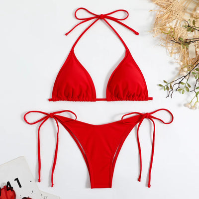Neon yellow halter bikini with triangle top and tie-side bottoms, displayed on a light wood surface. - Image 40