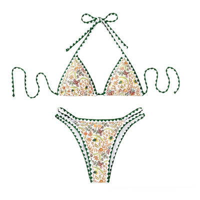 White halter bikini with green rickrack trim and a vibrant floral and bird print, featuring a triangle top and high-cut bottom. - Image 4