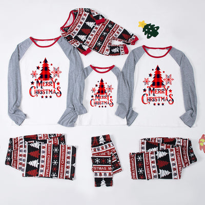 Family of four wearing matching Christmas pajamas with 'MERRY Christmas' text, leopard print, and plaid trees. - Image 19