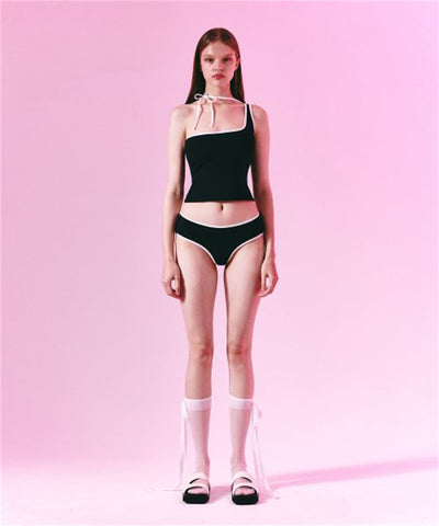 Women's light purple one-shoulder swimsuit with dark red contrast trim, lying on a striped blanket on green grass. - Image 13