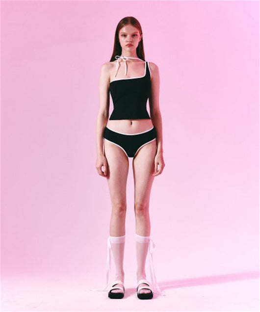Women's light purple one-shoulder swimsuit with dark red contrast trim, lying on a striped blanket on green grass. - Image 13