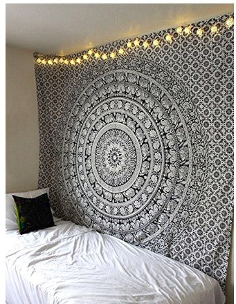 Black and white mandala tapestry with intricate floral and geometric patterns hanging on a bedroom wall. - Image 7