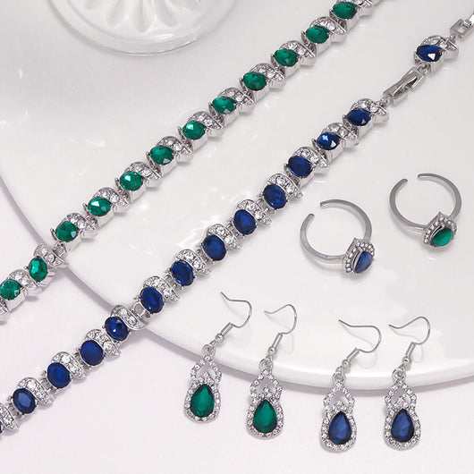 Light luxury jewelry set with silver-tone necklace, dangle earrings, open ring, and bracelet, all featuring emerald green teardrop and oval stones with clear rh - Image 11
