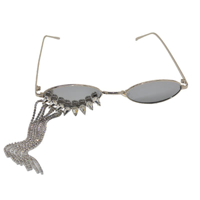 Silver oval-frame sunglasses with mirrored lenses and glamorous rhinestone tassels on one side, held by a gloved hand. - Image 5