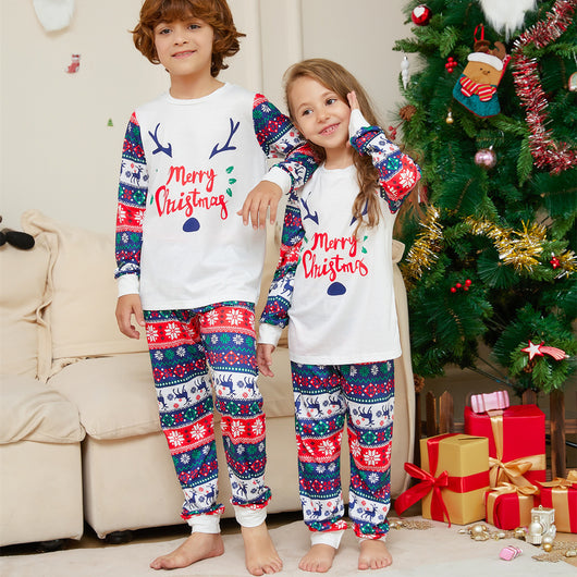 Family of four wearing matching white and red/blue Christmas pajamas with reindeer antlers and 'Merry Christmas' text. - Image 3