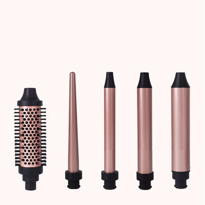Five rose gold and black interchangeable hair styling attachments, including a round brush and various curling barrels. - Image 7