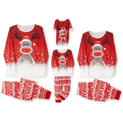 Family of four wearing matching red Christmas pajamas with reindeer and snowflake print, plus red pom-pom beanies. - Image 5