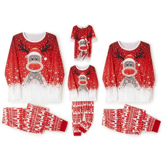 Family of four wearing matching red Christmas pajamas with reindeer and snowflake print, plus red pom-pom beanies. - Image 5