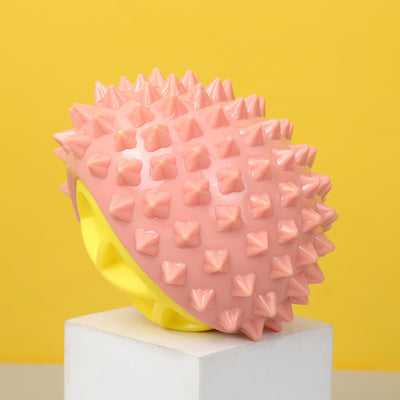 Pink and yellow durian-shaped chew toy with soft spikes, designed for pets, on a white display block. - Image 4