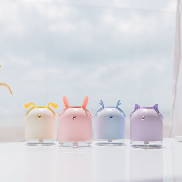 Yellow smart humidifier with cute animal ears and a gold emblem, featuring a transparent base for small spaces.