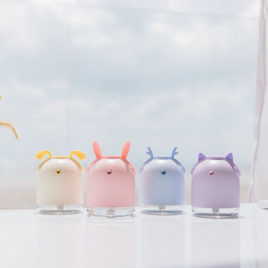Yellow smart humidifier with cute animal ears and a gold emblem, featuring a transparent base for small spaces.