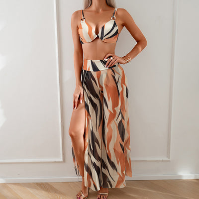 Women's pink, black, and white abstract striped bikini with a push-up top and strappy high-cut bottoms on a beach. - Image 6