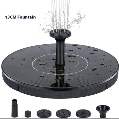 5W solar fountain kit with black solar panel on a ground stake, water pump, coiled hose, and various nozzles. - Image 4