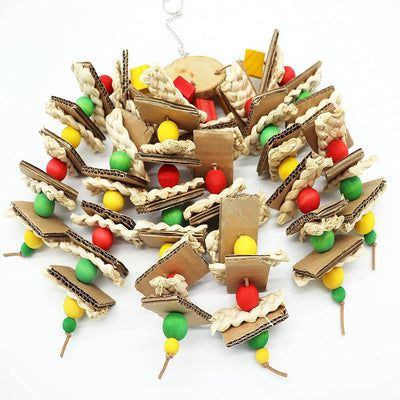 Parrot gnawing toy made of stacked cardboard, corn husks, and colorful wooden beads, with a parrot perched nearby. - Image 6