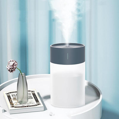 Cylindrical humidifier with a frosted white body and a light pink top, featuring a small mist outlet. - Image 12