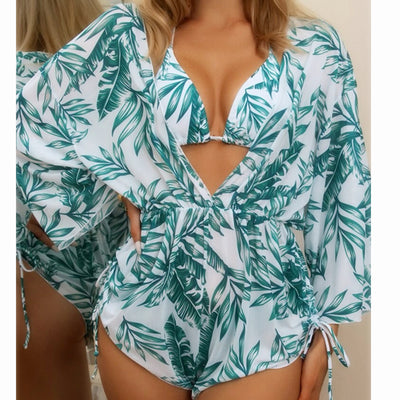 Woman wearing a white and black tie-dye beach cover-up romper with a deep V-neck and drawstring sides. - Image 5