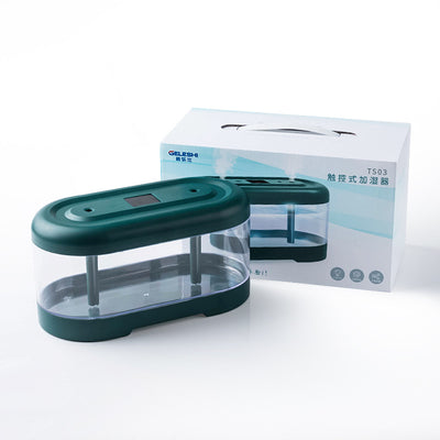 Dark green and clear oval USB humidifier with two mist outlets, shown next to its white product box. - Image 13