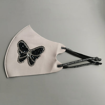 Black ear-mounted mask with a sparkling rhinestone bow pattern, featuring adjustable ear loops. - Image 10
