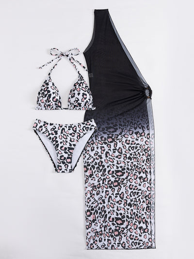 Woman in a three-piece leopard print bikini and sheer black sarong cover-up on a sunny beach. - Image 18