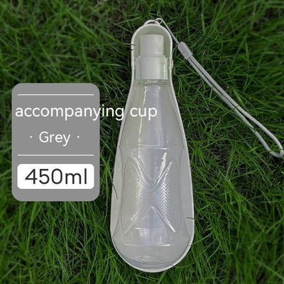 Yellow 450ml portable pet water bottle with a folding drinking trough and white wrist strap, on grass. - Image 7