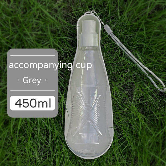 Yellow 450ml portable pet water bottle with a folding drinking trough and white wrist strap, on grass. - Image 7