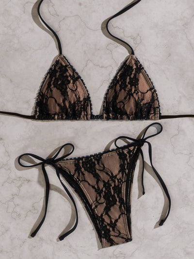 Black lace triangle-cup tie-front bikini swimsuit with nude lining, shown flat on a light marble surface. - Image 14