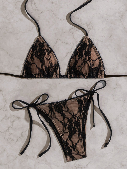 Black lace triangle-cup tie-front bikini swimsuit with nude lining, shown flat on a light marble surface. - Image 14