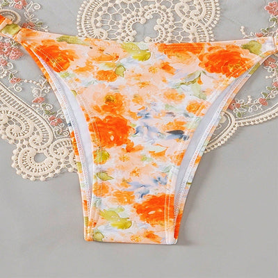 Orange floral print bandeau bikini with pom-pom trim and high-cut thong bottom with side rings. - Image 10
