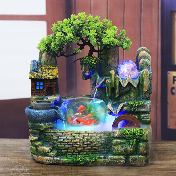 Desktop waterscape fish tank and creative humidifier with LED lights, miniature house, and artificial tree.