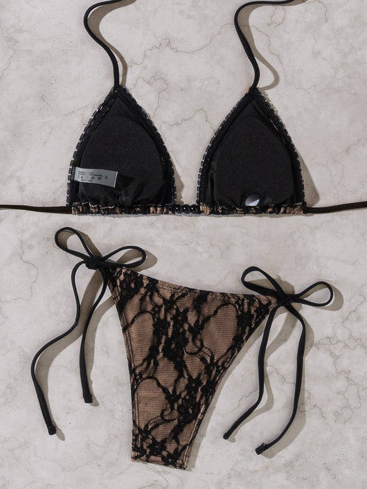Black lace triangle-cup tie-front bikini swimsuit with nude lining, shown flat on a light marble surface. - Image 15