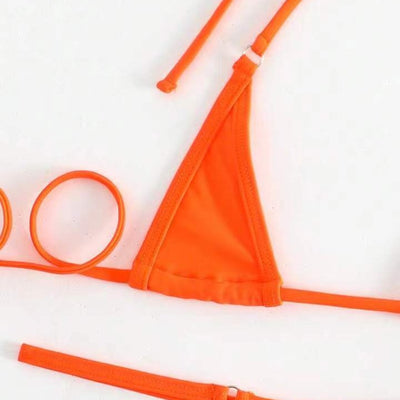 Orange solid color three-point bikini with a micro triangle top and thong bottom, modeled on a woman. - Image 4