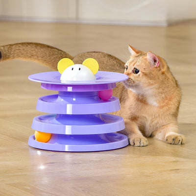 Brown tabby cat sniffing a black and orange multi-level rotating cat plate toy with colorful balls and bunny ears. - Image 9