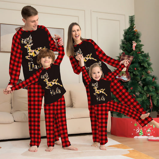 Kids' black and red buffalo plaid pajamas with a colorful deer graphic and "Kids" text on the top.