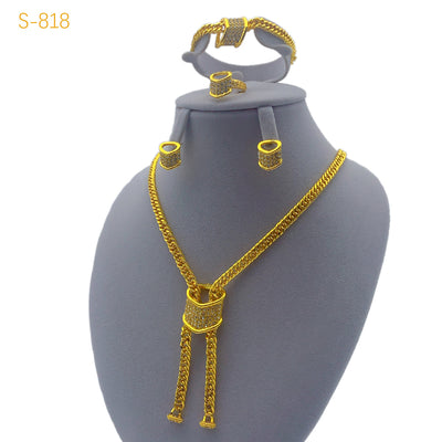 Gold-plated four-piece jewelry set with teardrop rhinestone necklace, bracelet, earrings, and ring on red velvet stands. - Image 9