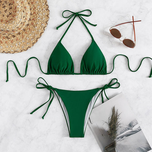 Neon yellow halter bikini with triangle top and tie-side bottoms, displayed on a light wood surface. - Image 36