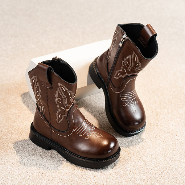 Girls' brown Martin boots with white ethnic embroidery, side zippers, and black soles, displayed on a light carpet. - Image 6