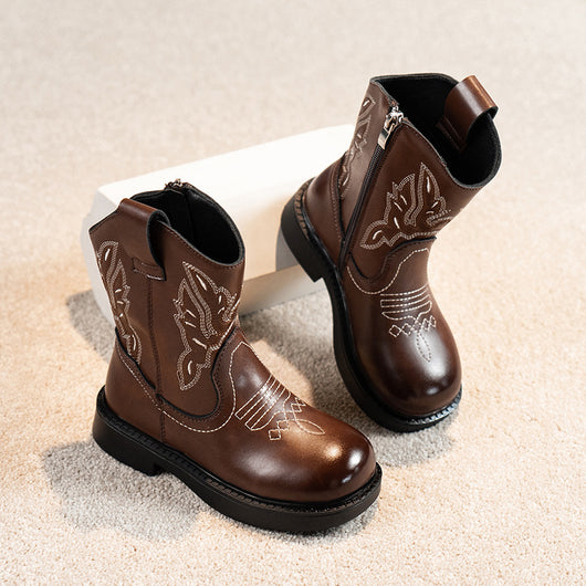 Girls' brown Martin boots with white ethnic embroidery, side zippers, and black soles, displayed on a light carpet. - Image 6