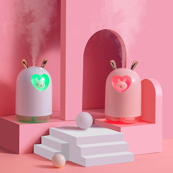 White rabbit humidifier with rose gold ears, a heart-shaped cutout, and a smiling bunny figure inside.