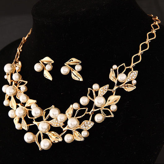 Gold-toned necklace and matching earrings set with faux pearls and clear rhinestones in an elegant leaf and vine design. - Image 9