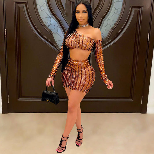 Black net hole hollow-out two-piece set with one-shoulder long-sleeve crop top and matching mini skirt.
