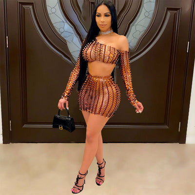 Black net hole hollow-out two-piece set with one-shoulder long-sleeve crop top and matching mini skirt.