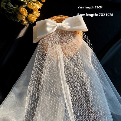 White birdcage veil with a cream satin bow and faux pearls, attached to a woven straw base, 80cm yarn length. - Image 9