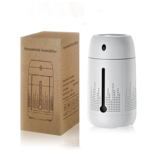White cylindrical household humidifier with a visible water level indicator, next to its brown cardboard packaging. - Image 9