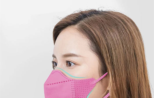 Peach disposable 3-layer face mask with perforated details worn by a person, offering comfortable daily protection. - Image 7