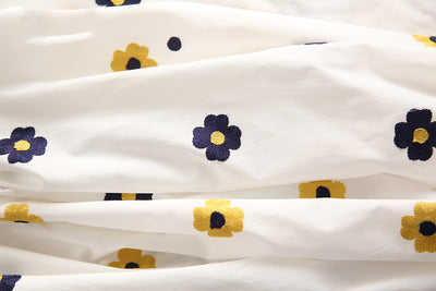 White pure cotton fabric with embroidered red cherries and green leaves, draped to show texture. - Image 2