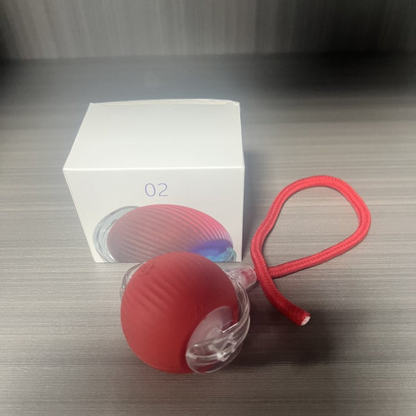 Gray intelligent automatic cat teasing ball with a clear section and braided cord, next to its white product box. - Image 6