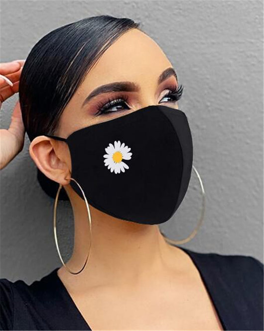 Black cotton face mask with a rhinestone flower design and "Be Kind" in pink rhinestones, worn by a person. - Image 5