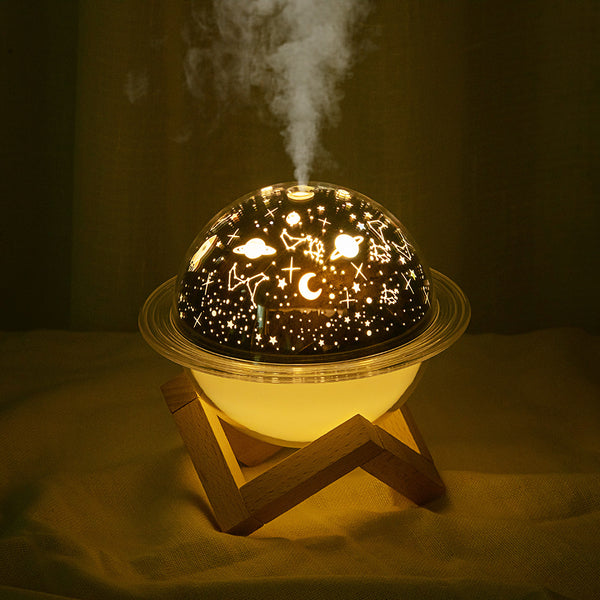 Christmas style planet light air purifier and humidifier, glowing green with festive projections on a wooden stand.