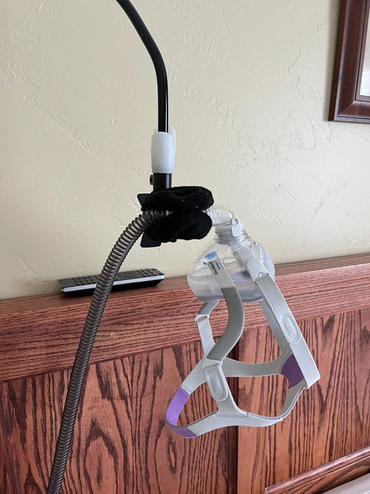 White flexible gooseneck ventilator hose bracket with a device clamp and a C-clamp base. - Image 9