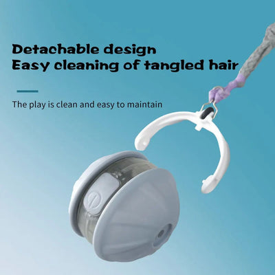 Light blue and white automatic rolling cat toy ball with a purple faux tail, featuring a power button. - Image 5